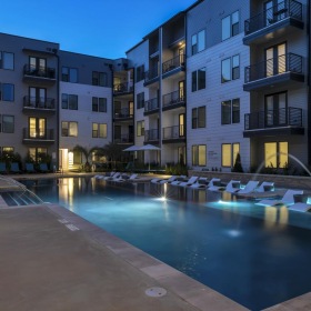 Shimmering resort-style pool a pool in a courtyard between buildings